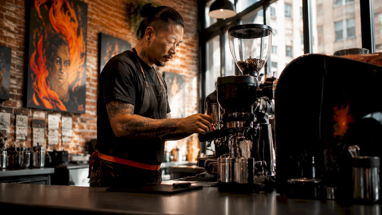 Barista preparing espresso shot at coffee shop