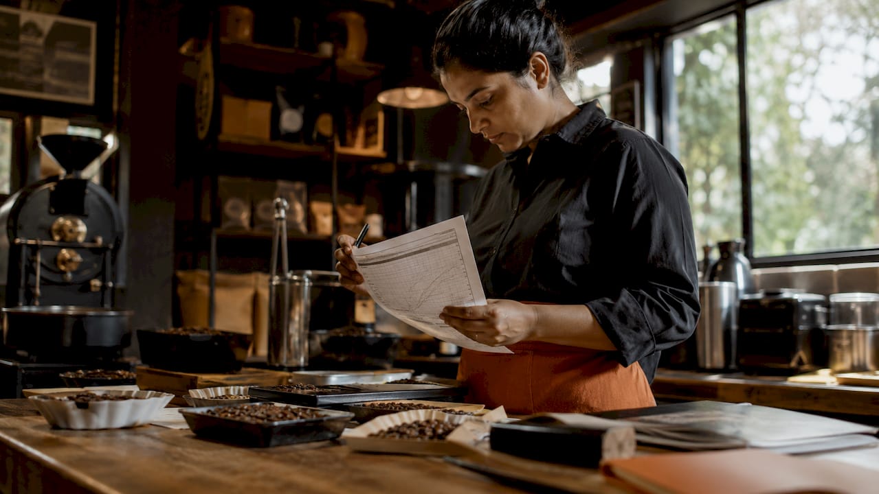 Person reviewing coffee roasting data at home