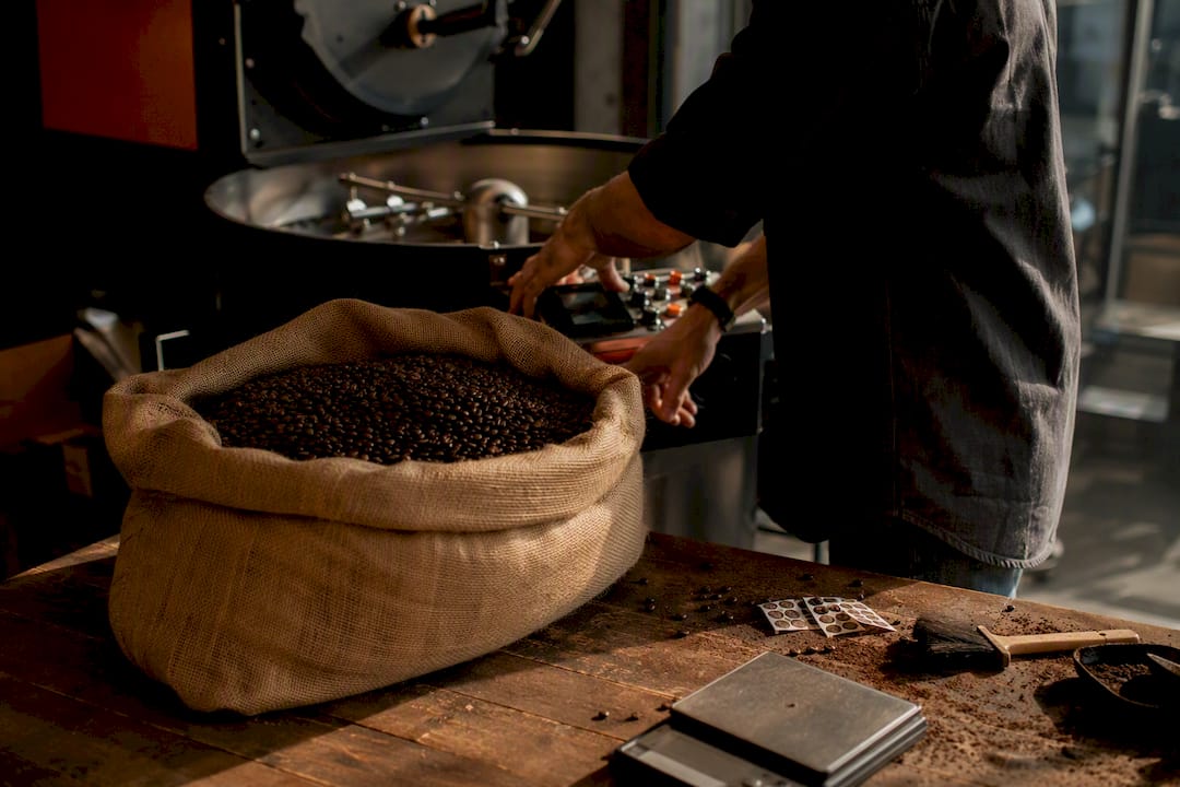 Hands adjusting coffee roast profile
