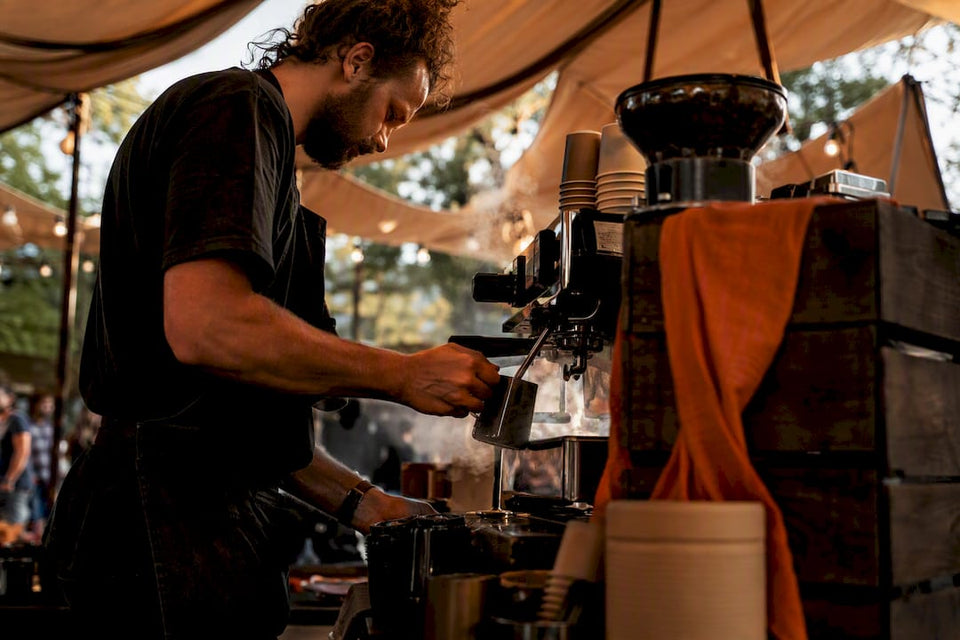 Barista preparing espresso at coffee cart